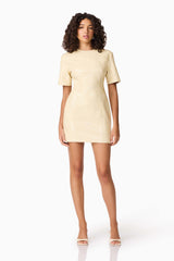 Brunette model wearing CURAAE Airlie Short Sleeve Mini Dress in Yellow posed shot