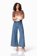 Brunette model wearing CURAAE Malta Knit Jumper in Brown & Beige posed crossing arms shot
