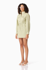 Brunette model wearing CURAAE Gretal Long Sleeve Mini Dress in Green side shot