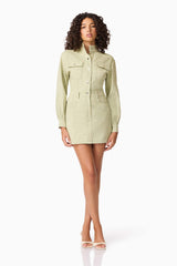 Brunette model wearing CURAAE Gretal Long Sleeve Mini Dress in Green posed shot