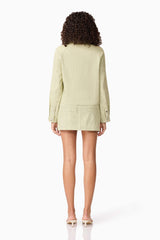 Brunette model wearing CURAAE Greta Jacket & Mini Skirt Set in Green back shot