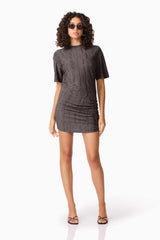 Brunette model wearing CURAAE Lavania Short Sleeve Mini Dress in Grey posed leaning shot