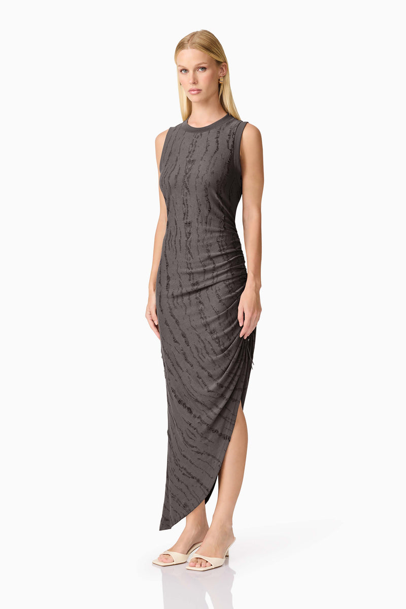 Blonde model wearing CURAAE Lavania Asymmetrical Midi Dress in Grey side shot