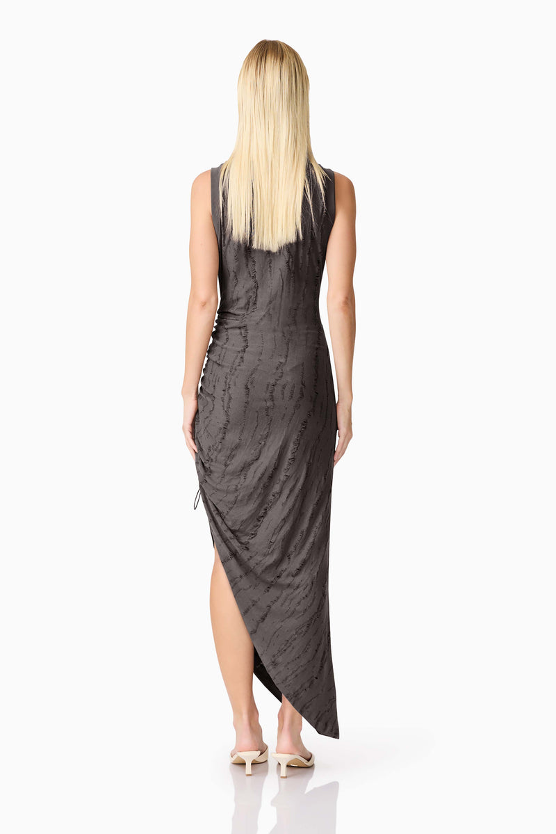 Blonde model wearing CURAAE Lavania Asymmetrical Midi Dress in Grey back shot