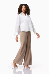 Brunette model wearing the Belle Shirt in White posed shot