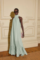 Model wears CURAAE Isaline Halter Maxi Dress in Sage Green with relaxed silhouette to high tea bridal shower event 