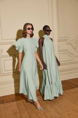 Models wearing CURAAE Isaline Puff Sleeve Midi Dress in Sage Green with a regular fit & CURAAE Isaline Halter Maxi Dress in Sage Green with relaxed silhouette to day lunch event 