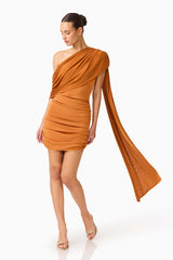 CURAAE Roya Asymmetric Mini Dress in Caramel Brown  with sash detail posed looking away shot