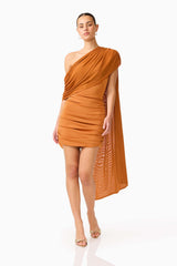CURAAE Roya Asymmetric Mini Dress in Caramel Brown  with sash detail posed leaning shot