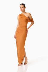CURAAE Roya Off Shoulder Maxi Dress in Caramel Brown with draped shoulder design posed looking away shot