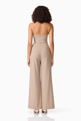 Brunette model wearing Orlena Jumpsuit in Beige Stripe back shot