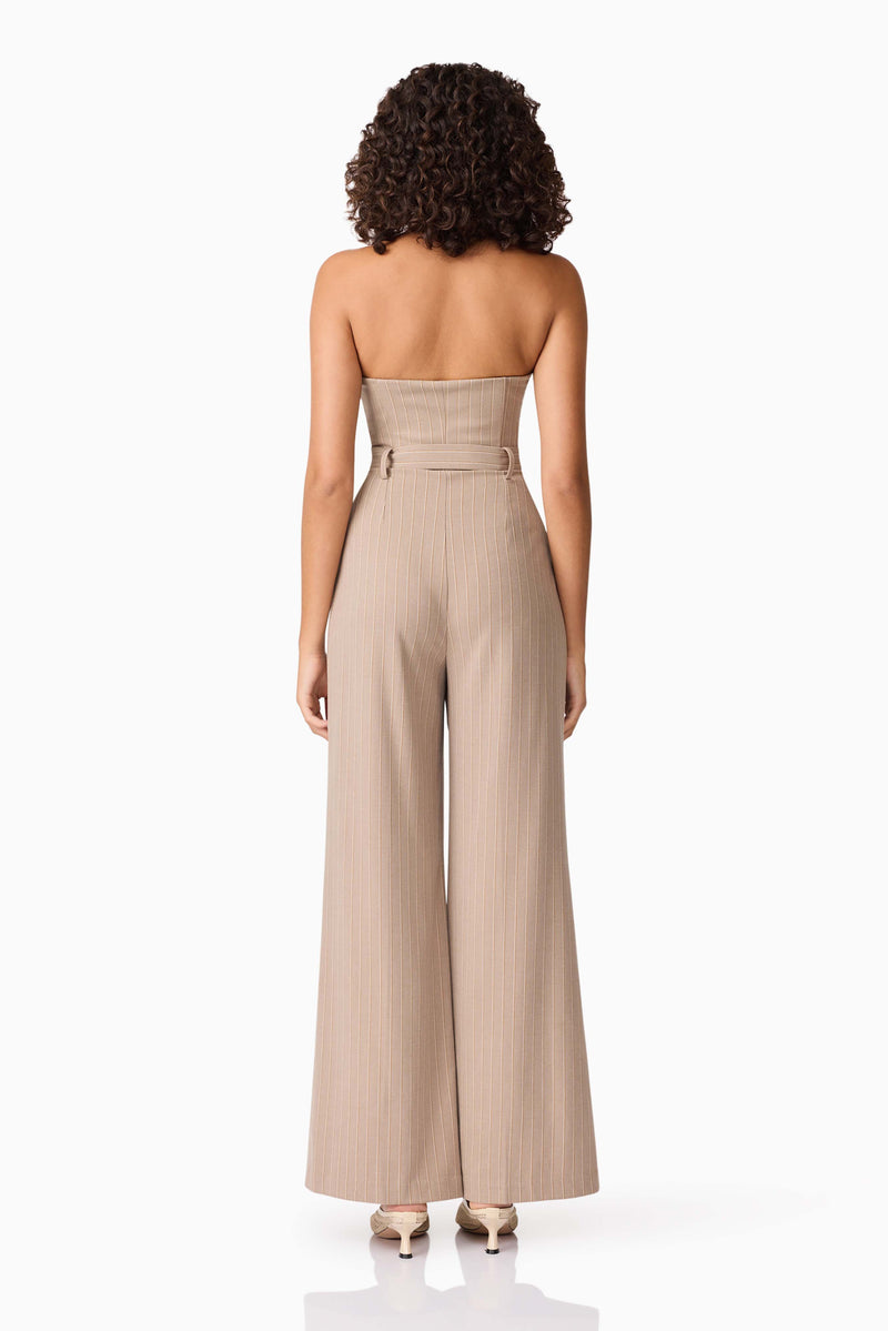 Brunette model wearing Orlena Jumpsuit in Beige Stripe back shot