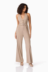 Brunette model wearing Orlena Jumpsuit in Beige Stripe side shot