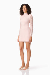 Brunette model wearing CURAAE Armelle Long Sleeve Mini Dress in Pink side shot