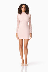 Brunette model wearing CURAAE Armelle Long Sleeve Mini Dress in Pink posed front shot