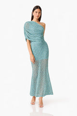 CURAAE Orel Asymmetric Maxi Dress in Blue with draped shoulder design & sheer skirt panel posed shot 