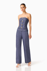 CURAAE Vana Denim Jumpsuit in Blue with strapless neckline & front botton detail posed shot 