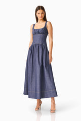 CURAAE Vana Denim Maxi Dress in Blue with scoop neckline & drop waist posed shot