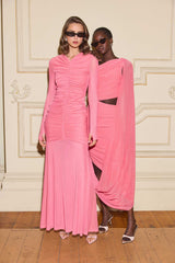 Model wearing the CURAAE Cleo Long Sleeve Maxi Dress in Pink & CURAAE Cleo One Shoulder Midi Dress in Pink to a cocktail event 