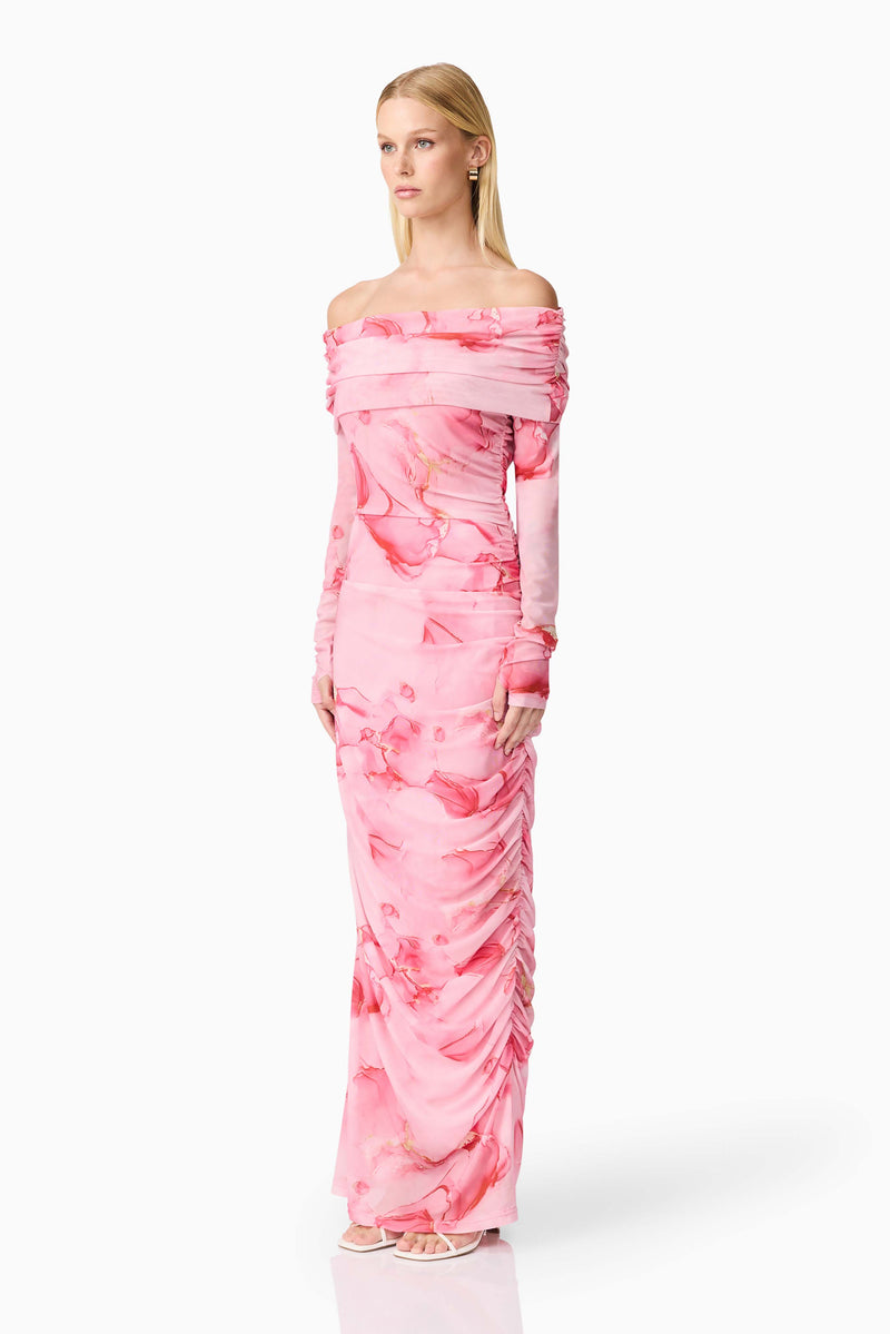 Blonde model wearing CURAAE Rosalia Off The Shoulder Maxi Dress in Pink Floral side shot