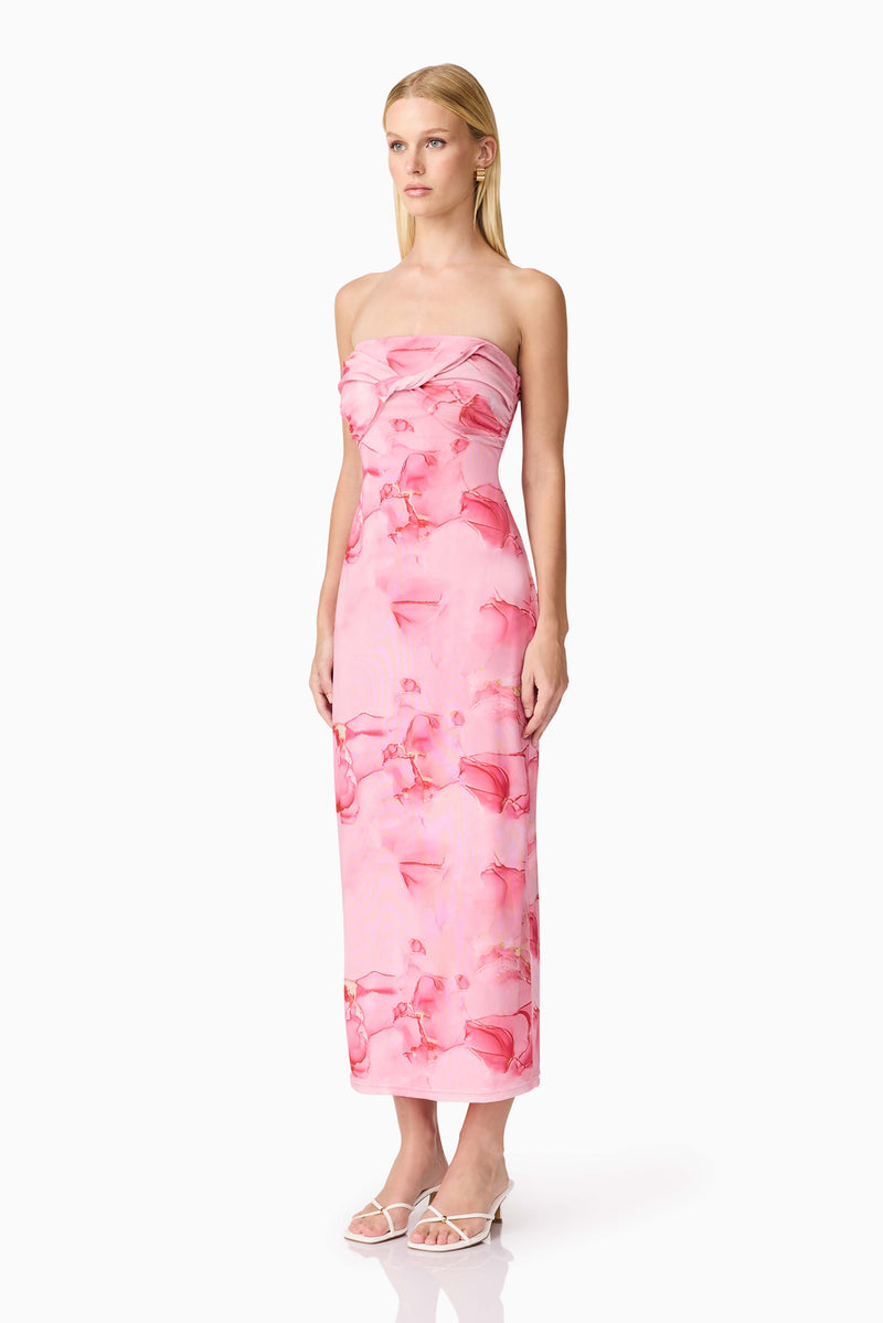Brunette model wearing CURAAE Rosalia Strapless Midi Dress in Pink Floral side shot