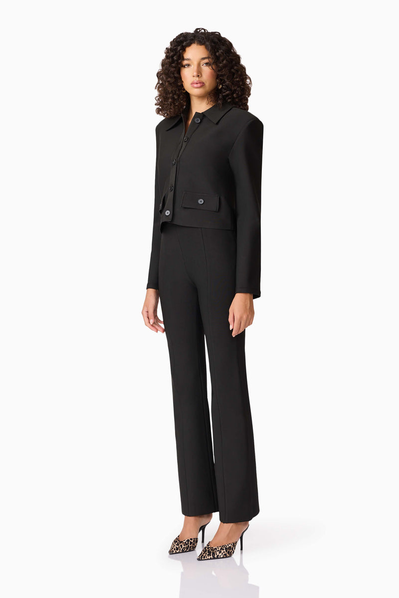 Brunette model wearing CURAAE Nora Jacket & Pants Set in Black side shot