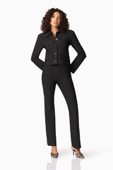 Brunette model wearing CURAAE Nora Jacket & Pants Set in Black posed hands on hip shot