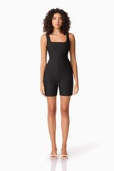Brunette model wearing CURAAE Nora Unitard in Black front shot