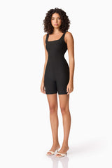 Brunette model wearing CURAAE Nora Unitard in Black side shot