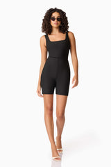 Brunette model wearing CURAAE Nora Unitard in Black posed shot