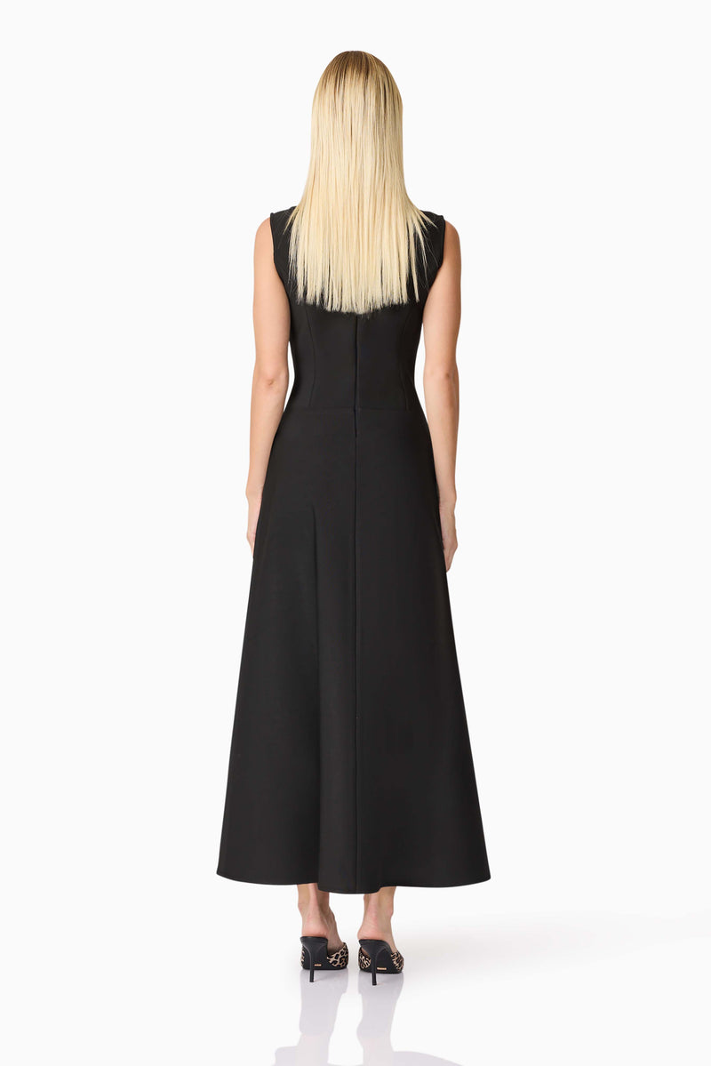 Blonde model wearing CURAAE Nora Sleeveless Midi Dress in Black back shot