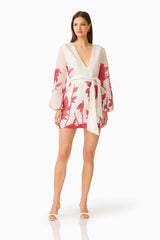 CURAAE Viva Long Sleeve Mini Dress in White and Red with long sleeves & v-neckline posed looking away shot