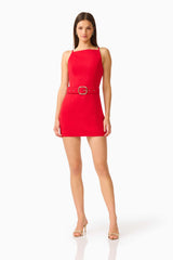CURAAE Aris Mini Dress in Red with Boat Neckline and Belt Buckle Posed Lean Shot