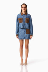 Brunette model wearing CURAAE Rhea Denim Jacket & Skirt Set front pose