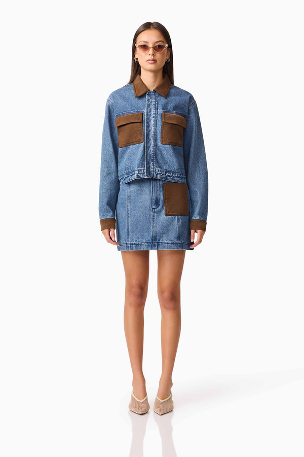 Brunette model wearing CURAAE Rhea Denim Jacket & Skirt Set front pose