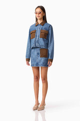 Brunette model wearing CURAAE Rhea Denim Jacket & Skirt Set side pose