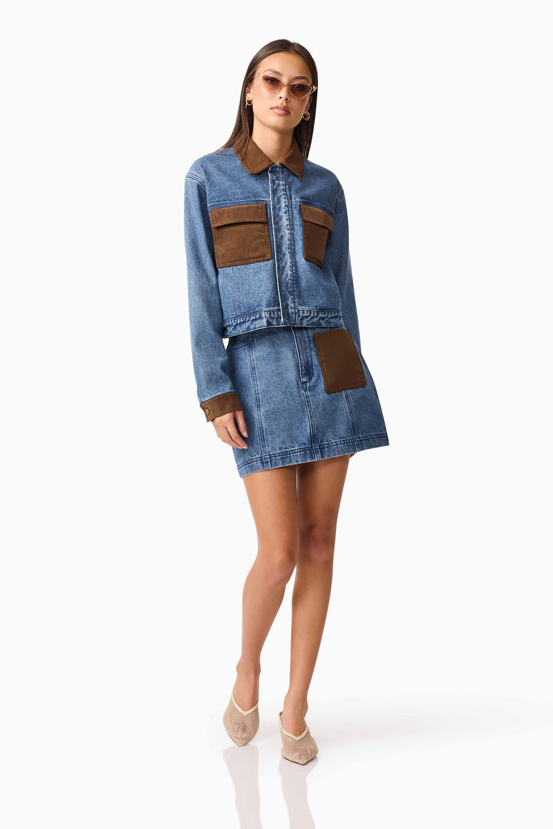 Brunette model wearing CURAAE Rhea Denim Jacket & Skirt Set posed