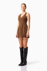 Blonde model wearing CURAAE Venus Suede Mini Dress in Brown side pose