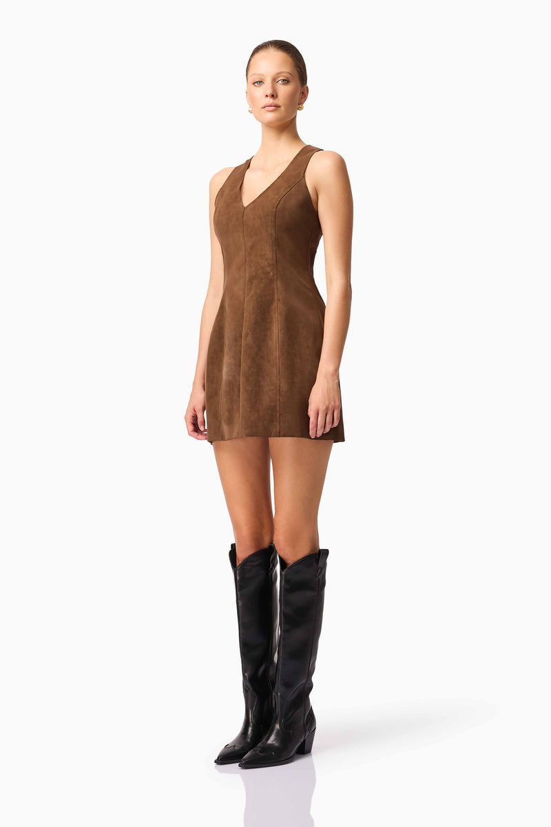 Blonde model wearing CURAAE Venus Suede Mini Dress in Brown side pose