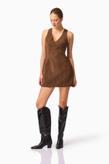 Blonde model wearing CURAAE Venus Suede Mini Dress in Brown posed