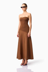 Blonde model wearing CURAAE Zahara Strapless Maxi Dress in Brown side pose