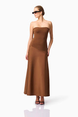 Blonde model wearing CURAAE Zahara Strapless Maxi Dress in Brown posed