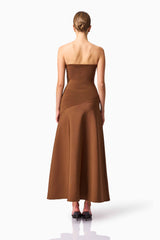 Blonde model wearing CURAAE Zahara Strapless Maxi Dress in Brown back pose