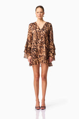 Blonde model wearing CURAAE Zali Long Sleeve Mini Dress in Leopard Print front pose