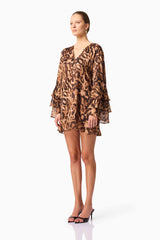 Blonde model wearing CURAAE Zali Long Sleeve Mini Dress in Leopard Print side pose
