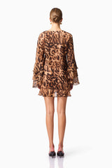 Blonde model wearing CURAAE Zali Long Sleeve Mini Dress in Leopard Print back pose