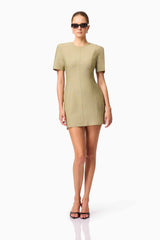 Blonde model wearing CURAAE Dua Short Sleeve Mini Dress in Green posed