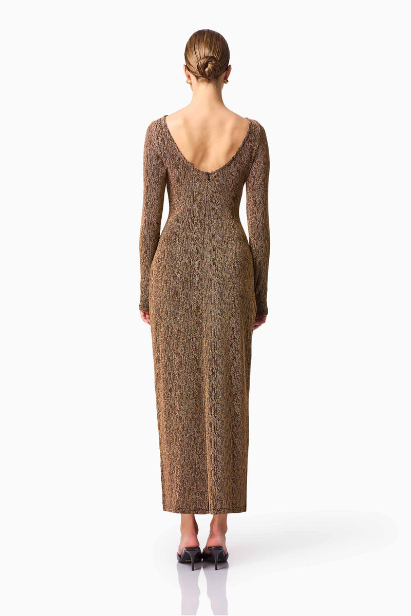 Blonde model wearing CURAAE Emery Long Sleeve Maxi Dress in Gold back pose