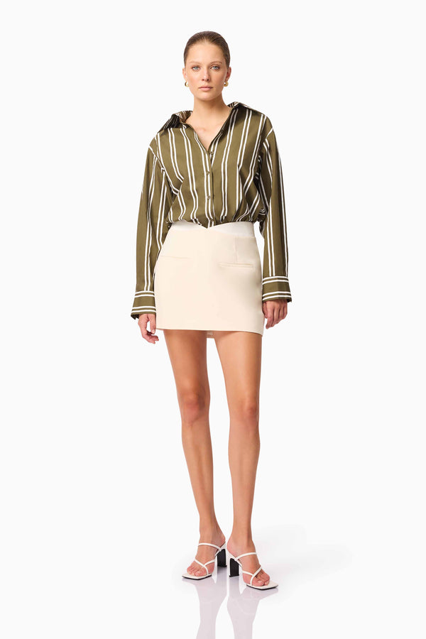 Brunette model wearing Giverny Stripped Shirt in Green posed shot