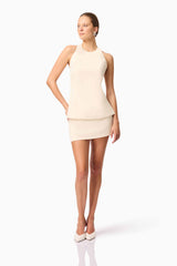 Blonde model wearing CURAAE Ceres Halter Top & Mini Skirt Set In White posed